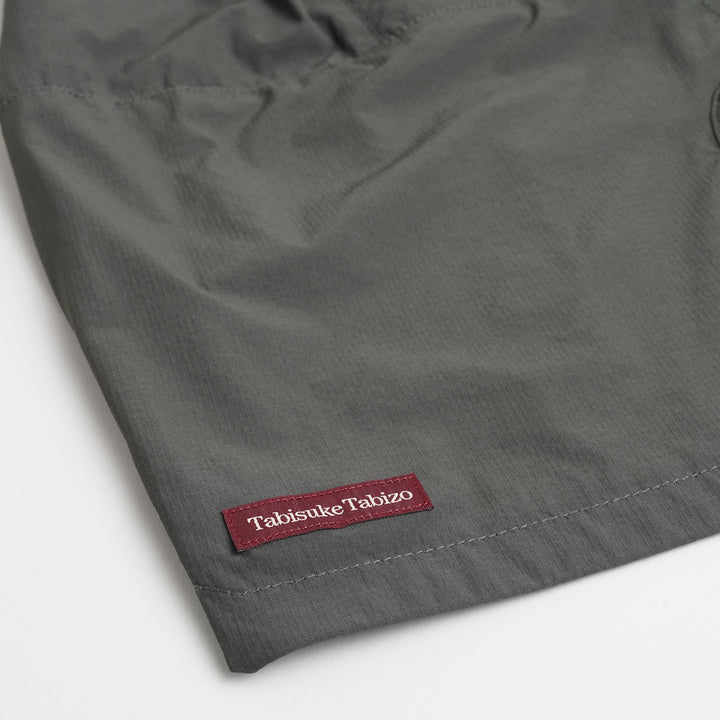 T2 Traverse Shorts trail running shorts in blue-gray with stretch nylon fabric and zippered pockets