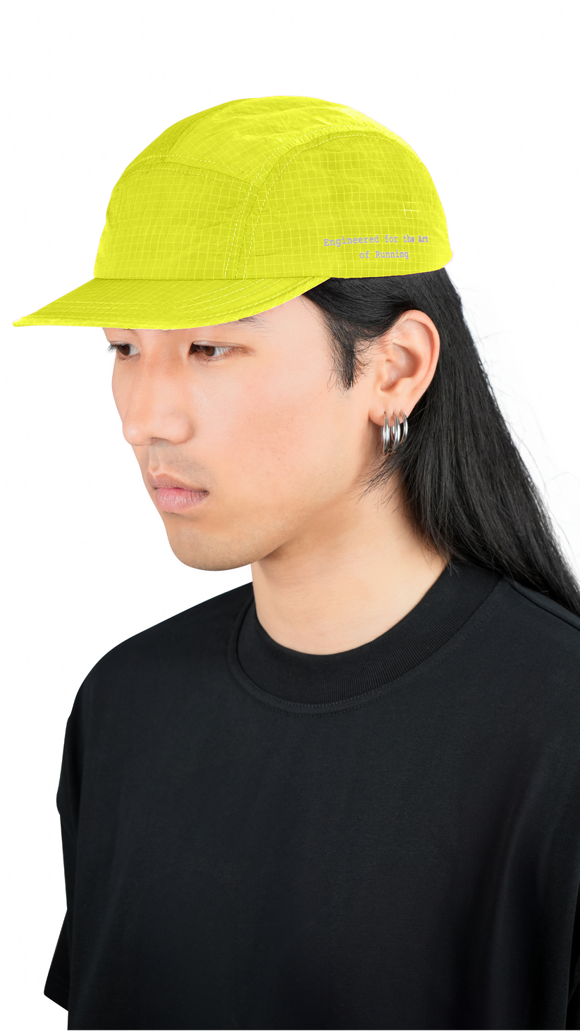 Lievre Running yellow performance running cap, lightweight technical fabric with adjustable back cord and “Engineered for the Art of Running” text on the side panel.